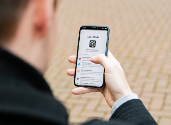 Person using Find My app on iPhone to locate a lost Apple Watch